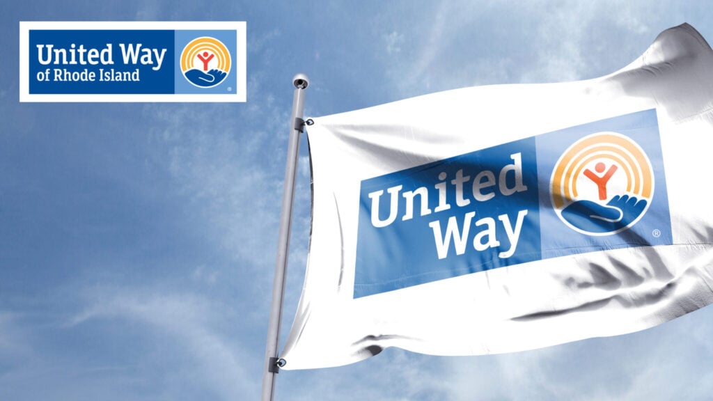 A flag against a blue sky featuring the United Way of Rhode Island logo