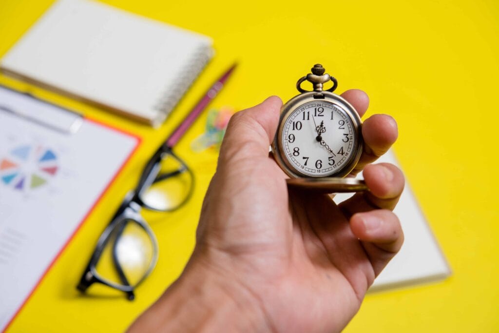 A close-up of a hand holding a small stopwatch
