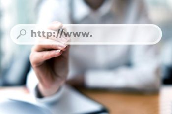 A website url is superimposed against a person editing it in the background