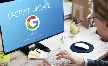 A user sits at an open laptop with the Google logo displyad onscreen along with text that reads "latest update"