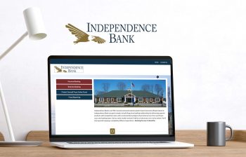 A laptop displays the homepage of the Independence Bank website