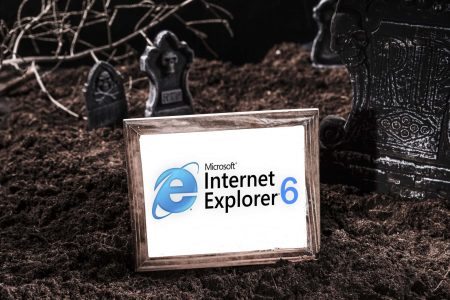 A distressed picture frame of the internet explorer logo version 6 in a graveyard