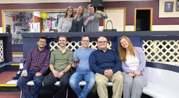 The staff of Brave River Solutions celebrate at a company bowling outing.