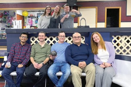 The staff of Brave River Solutions celebrate at a company bowling outing.